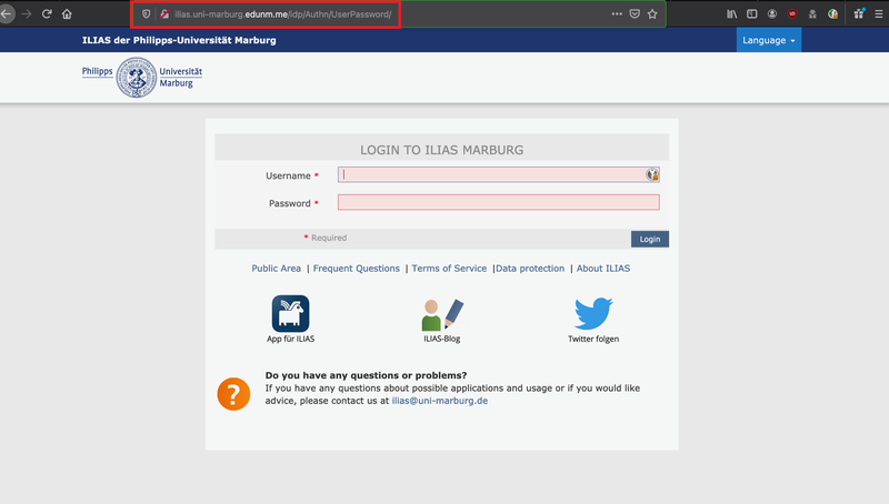 Screenshot of a fake login page for ILIAS at Philipps-Universität Marburg. The URL in the browser is: ilias.uni-marburg.edunm.me/idp/Authn/UserPassword/ and thus emphasises the domain ‘edunm.me’, which does not belong to the official university. The site asks for a user name and password. The layout and logo imitate a real university website and there are links to ‘Public Area’, ‘Frequent Questions’, ‘Terms of Service’, ‘Data protection’ and ‘About ILIAS’ as well as icons for the app, blog and Twitter. At the bottom there is a contact option at ilias@uni-marburg.de.