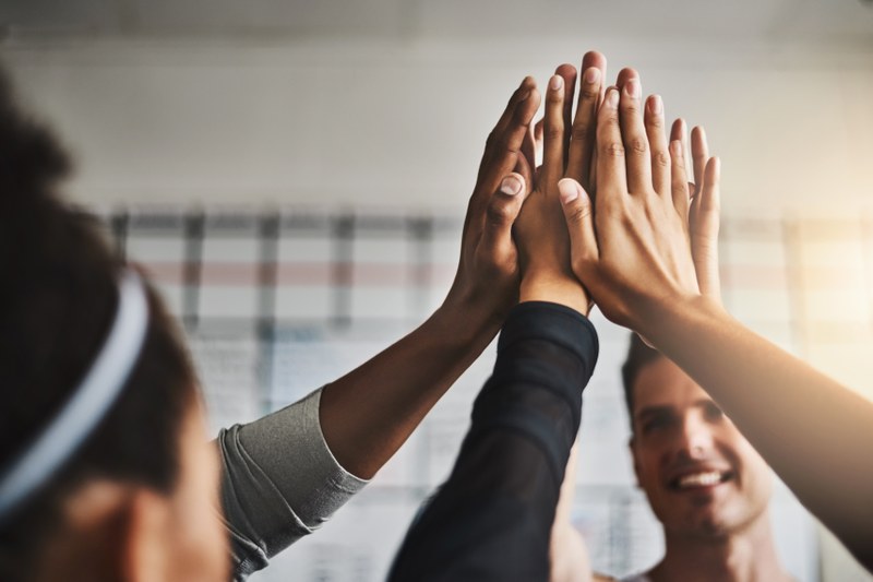 Several people giving each other a high five